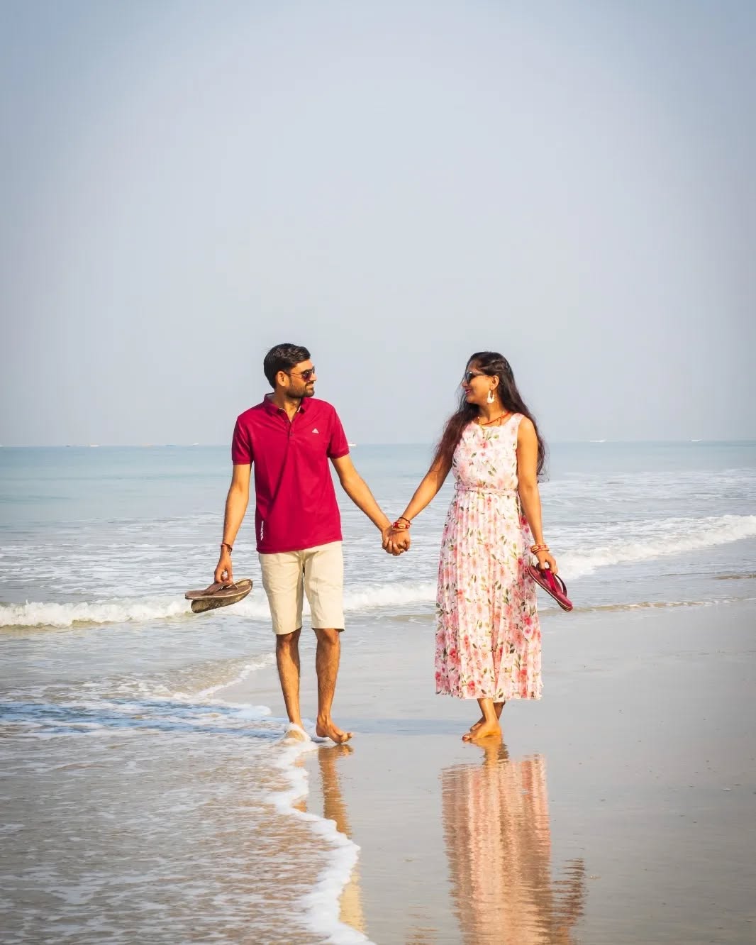 Honeymoon couple walking on the Calangute beach, Goa.
